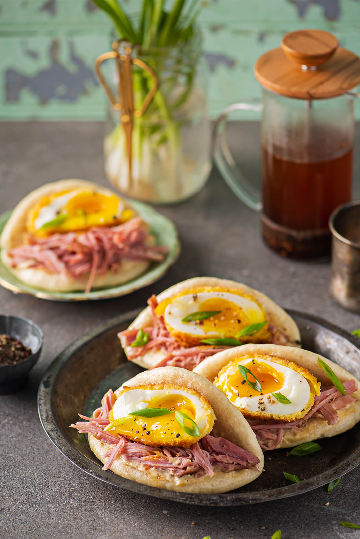 Bao bun sandwich with fried eggs and shredded ham